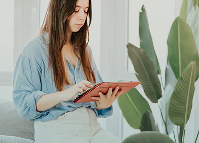 Plan member reviewing her care plan on a tablet
